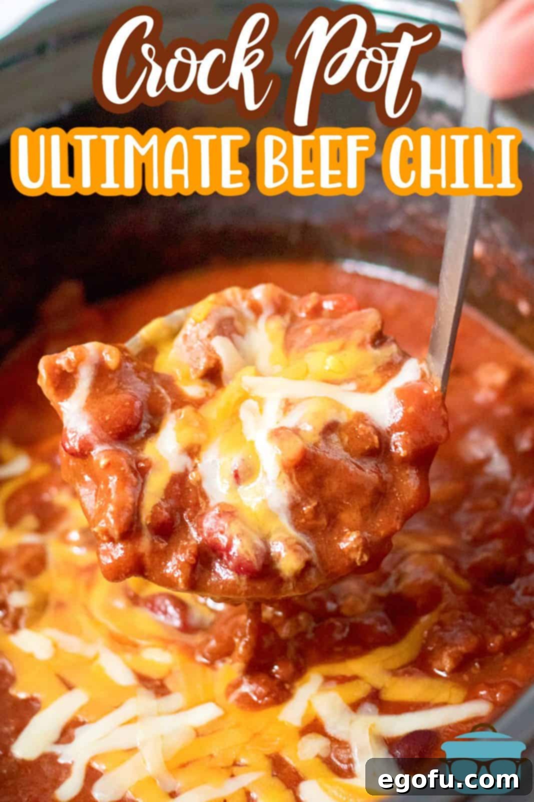 A ladle lifts a generous portion of Slow Cooker Ultimate Beef Chili from the slow cooker, showcasing its rich, thick texture.