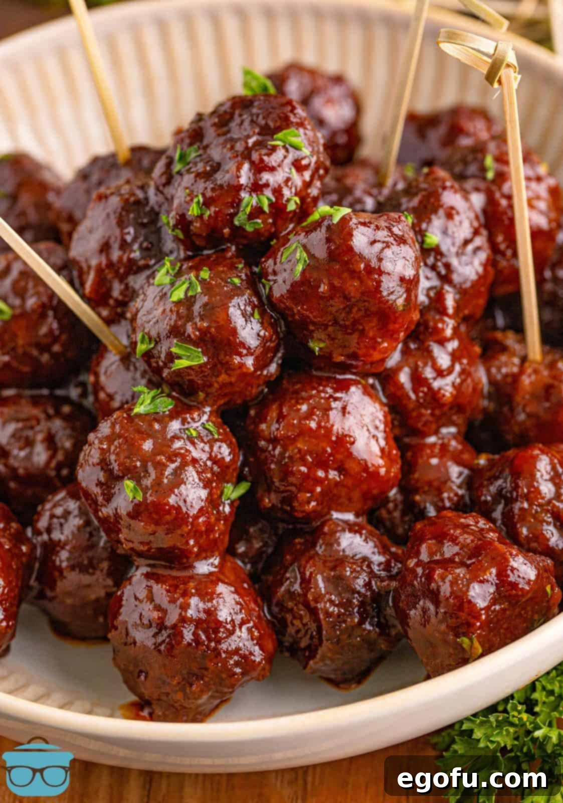 Sweet & Tangy Grape Jelly Meatballs 2 Finished Homemade Grape Jelly Meatballs in dish with some cocktail toothpicks.