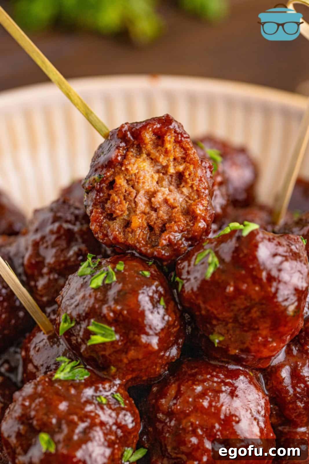 Sweet & Tangy Grape Jelly Meatballs 12 Stacked Homemade Grape Jelly Meatballs with bite taken out of one.
