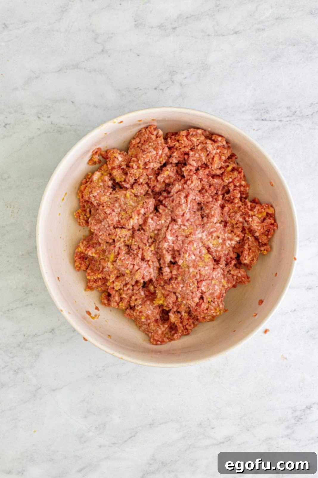 Sweet & Tangy Grape Jelly Meatballs 6 Ground beef and pork mixed with the breadcrumb mixture.