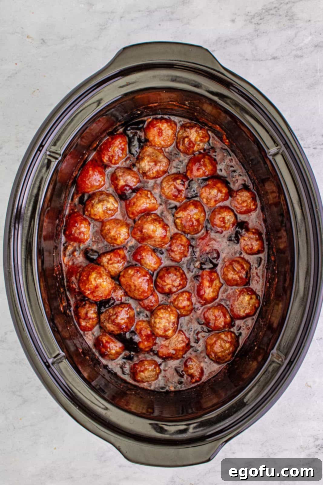 Sweet & Tangy Grape Jelly Meatballs 10 Grape jelly and chili sauce added to crock pot and mixed together with meatballs.