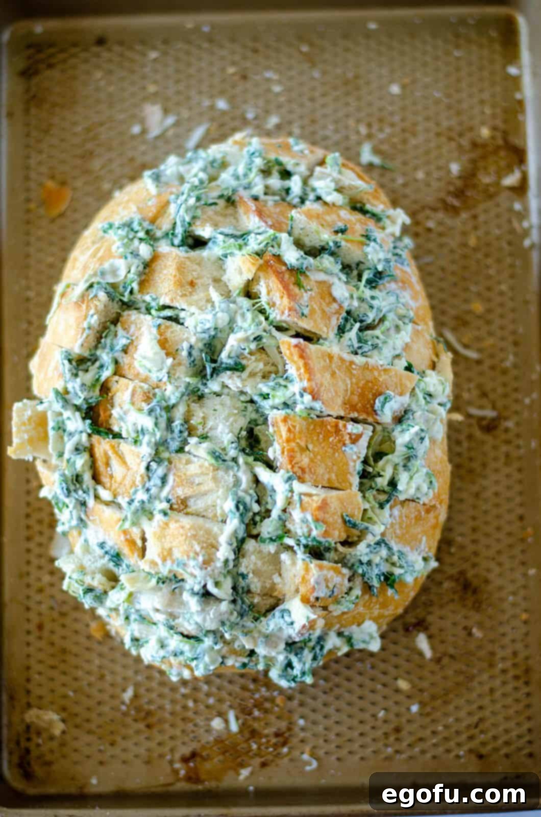 Spinach artichoke dip stuffed into cut bread.