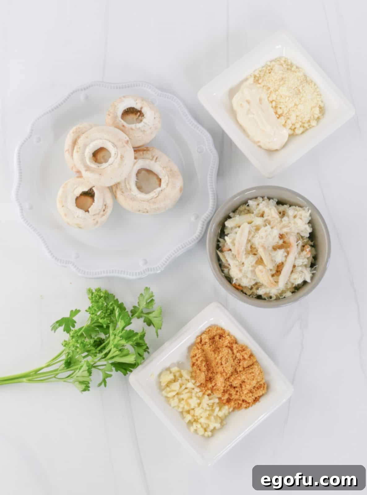 Savory Crab-Filled Mushroom Bites 4 Ingredients needed: white mushrooms, crab meat, mayonnaise, garlic croutons, parmesan cheese, garlic, parsley.