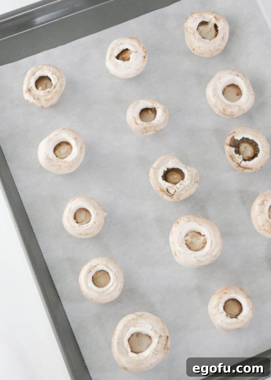Savory Crab-Filled Mushroom Bites 5 Mushroom caps on parchment lined baking sheet.