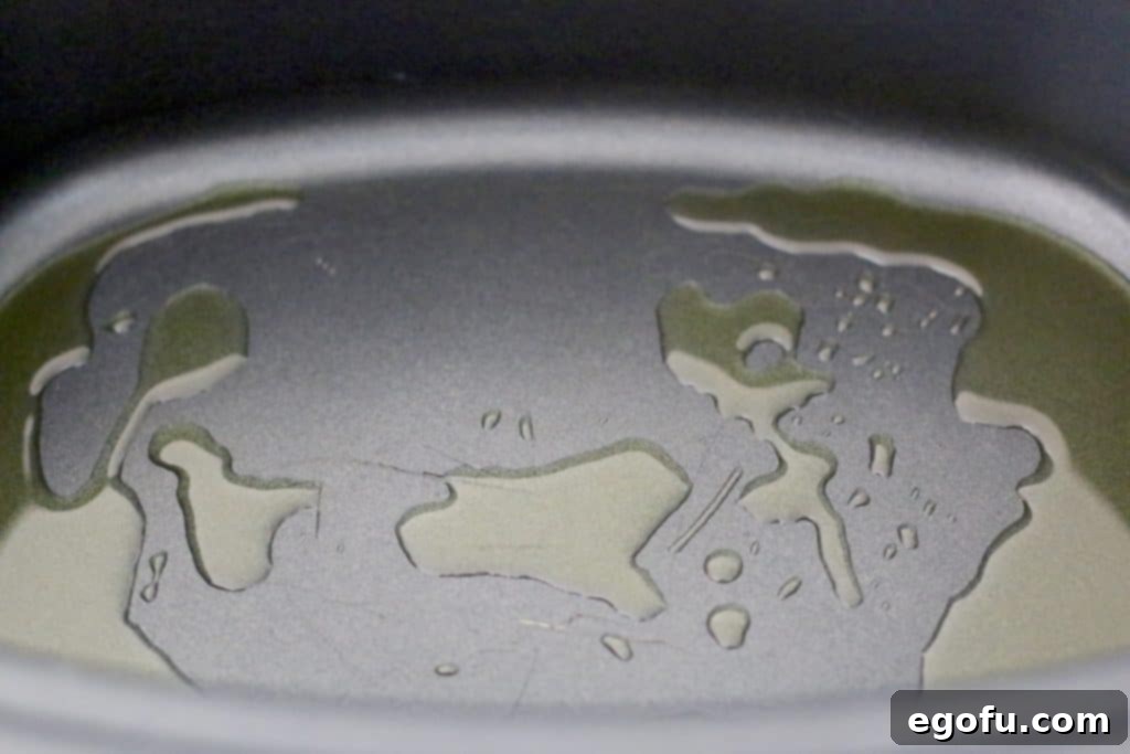 Slow Simmered Homemade Meatballs with Zesty Marinara 5 olive oil in the bottom of an oval slow cooker