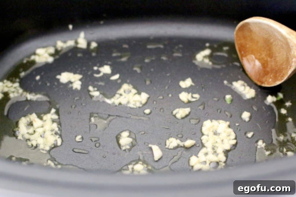 Slow Simmered Homemade Meatballs with Zesty Marinara 6 minced fresh garlic added to olive oil to lightly cook