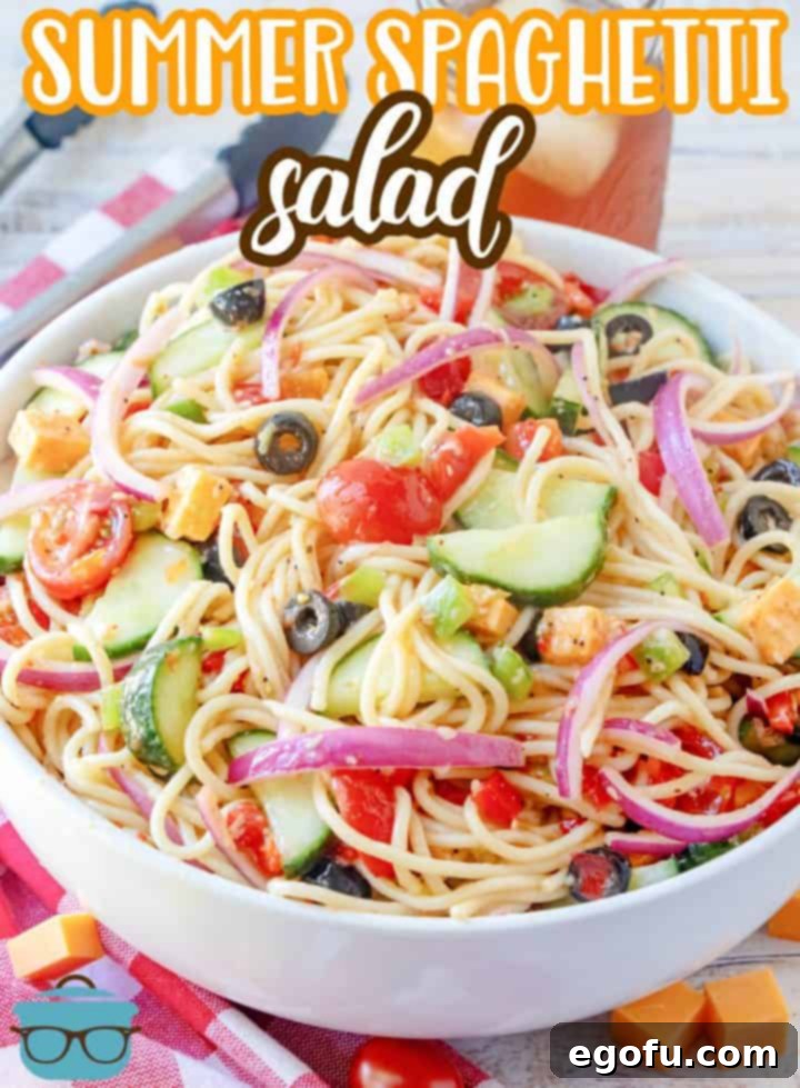 Summer Spaghetti Salad recipe from The Country Cook, salad shown in a large white serving bowl with glass of sweet train the background. 