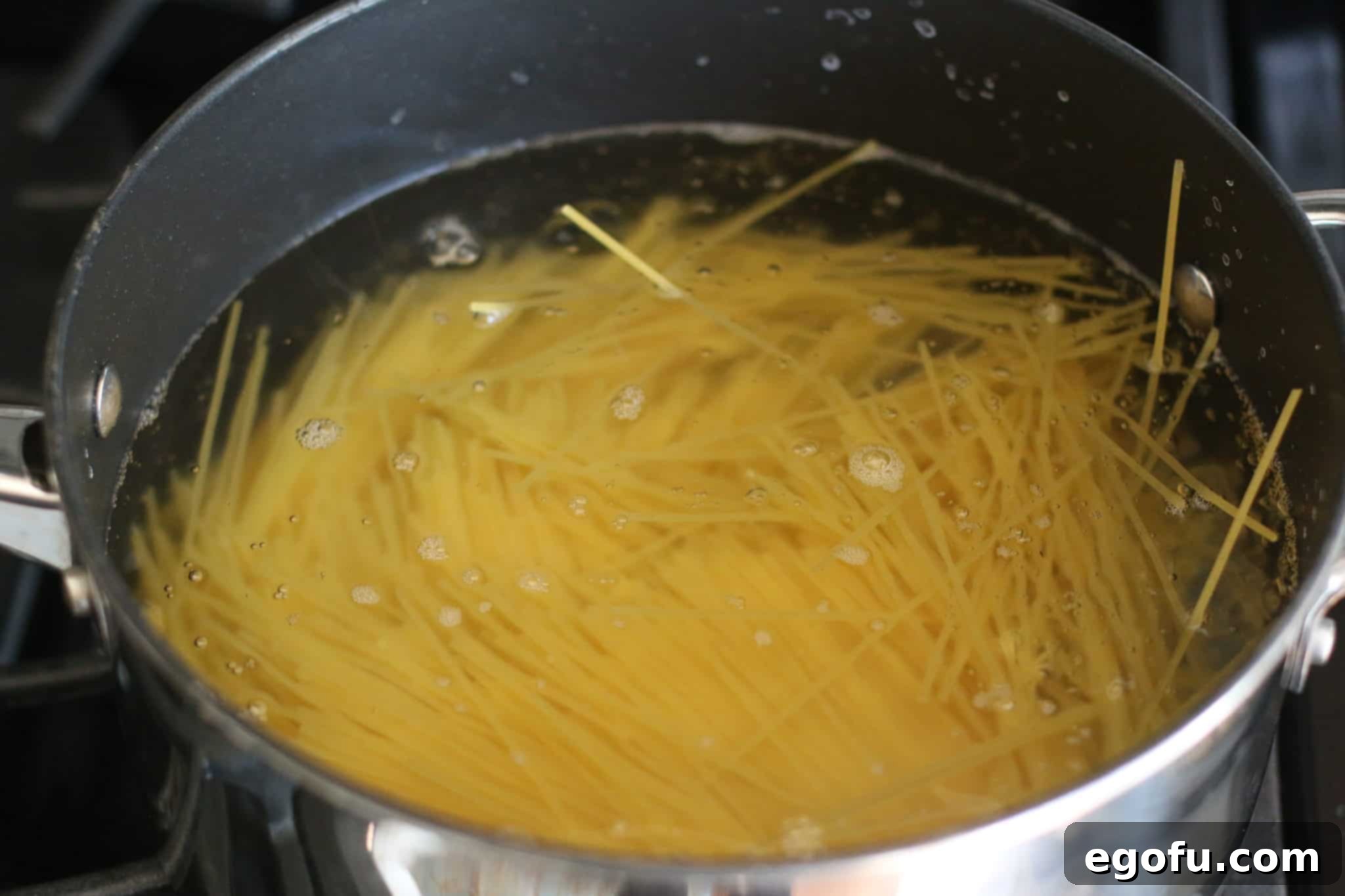 A pot of spaghetti noodles cooking in salted boiling water, ready for the summer salad.