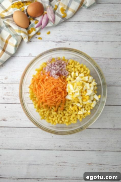 Creamy Hawaiian Macaroni Salad 11 shredded carrots, diced shallots and diced boiled eggs added to boil with macaroni.