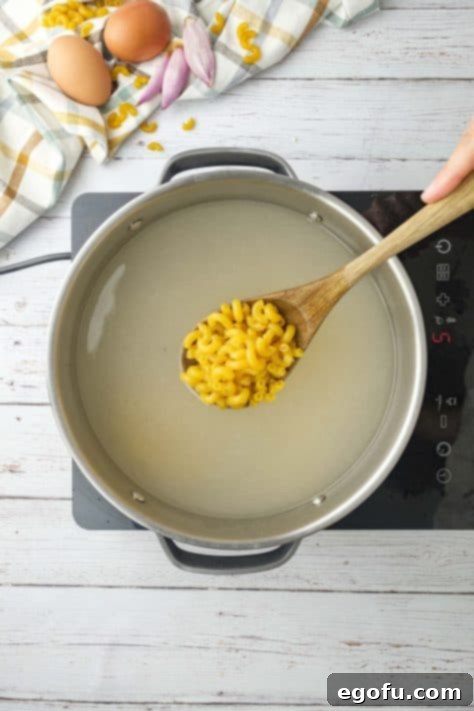 Creamy Hawaiian Macaroni Salad 9 boiled macaroni noodles in a pot.