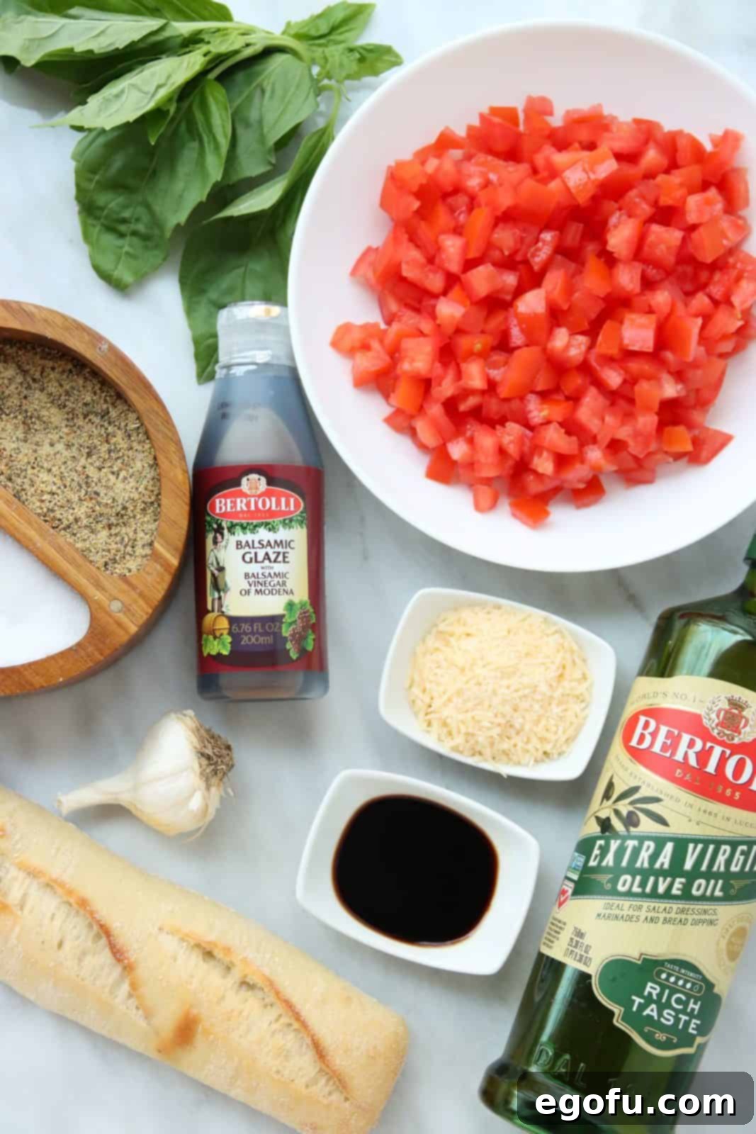 Garlic Parmesan Crostini 4 Ingredients needed: olive oil, french baguette, roma tomatoes, garlic, basil leaves, balsamic vinegar, salt, pepper and parmesan cheese.