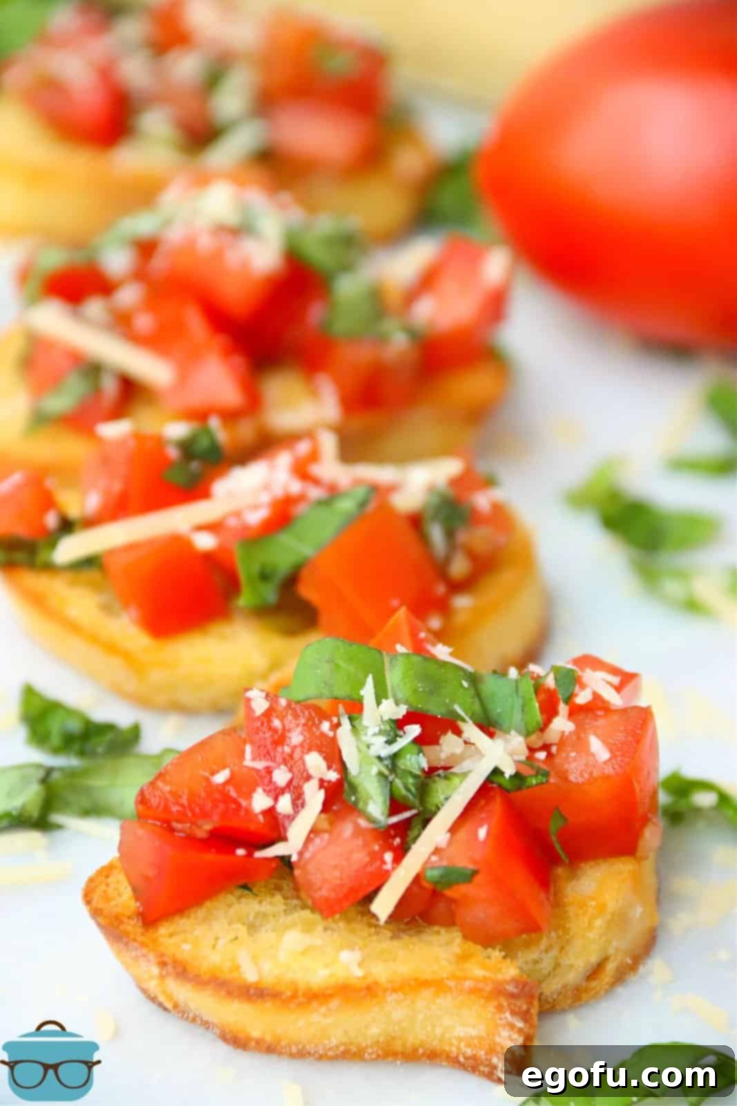 Garlic Parmesan Crostini 8 Finished Parmesan Bruschetta on white platter.