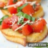 Garlic Parmesan Crostini 10 Square image close up of Parmesan Bruschetta on baguette.