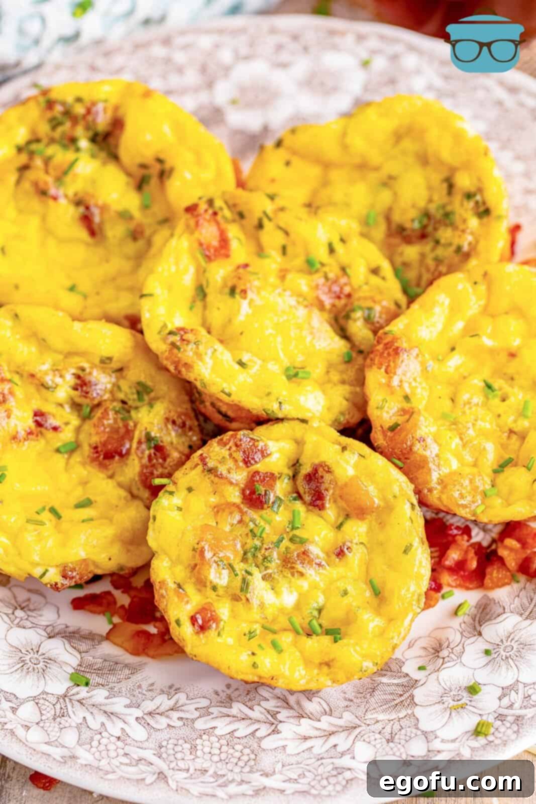 Starbucks' Bite-Sized Egg Delights 2 A stack of golden brown, fluffy Starbucks-style egg bites resting elegantly on a brown and white floral plate, ready to be served and savored for breakfast.