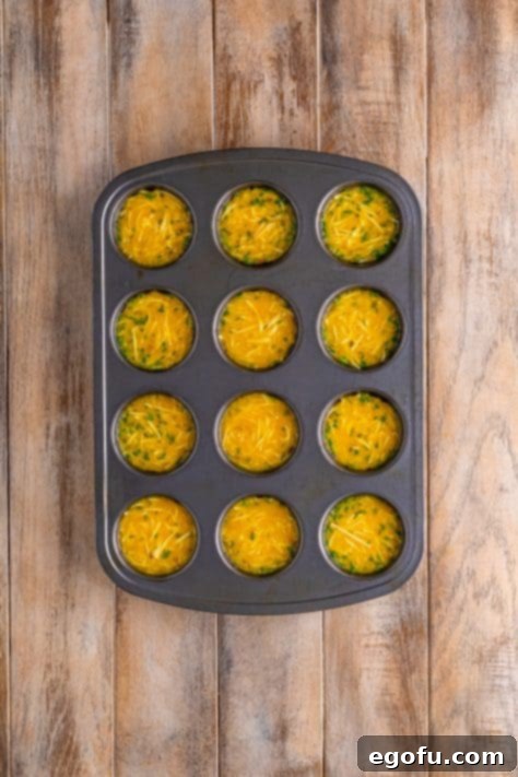 Starbucks' Bite-Sized Egg Delights 13 Bacon pieces being gently pressed into the egg mixture in a muffin tin with a fork, ensuring even distribution.
