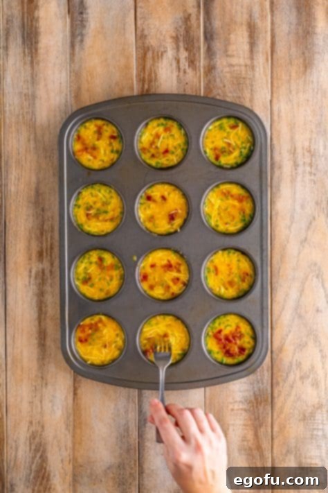Starbucks' Bite-Sized Egg Delights 14 Fully baked egg bites with beautifully golden brown edges, perfectly risen in a muffin tin.