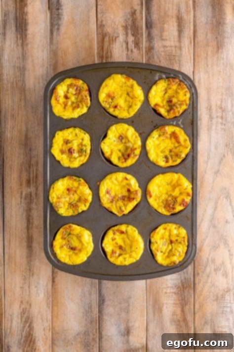 Starbucks' Bite-Sized Egg Delights 15 A stack of golden egg bites displayed on a brown and white floral plate, ready to be served and enjoyed.