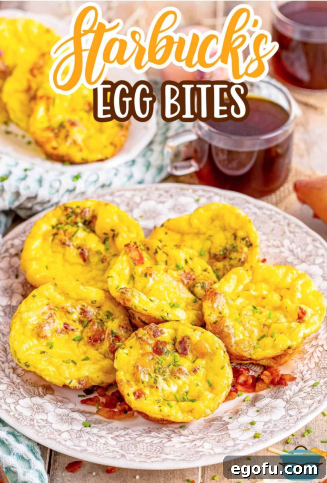 Starbucks' Bite-Sized Egg Delights 4 A beautiful stack of golden brown Starbucks-style egg bites on a quaint brown and white floral plate, artfully positioned with a clear glass of steaming coffee subtly blurred in the background, creating a comforting and inviting breakfast scene.