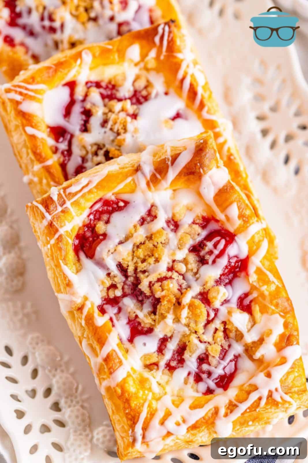 Buttery Cherry Crumble Danishes 2 Overhead of Cherry Crumble Danishes layered on white platter.