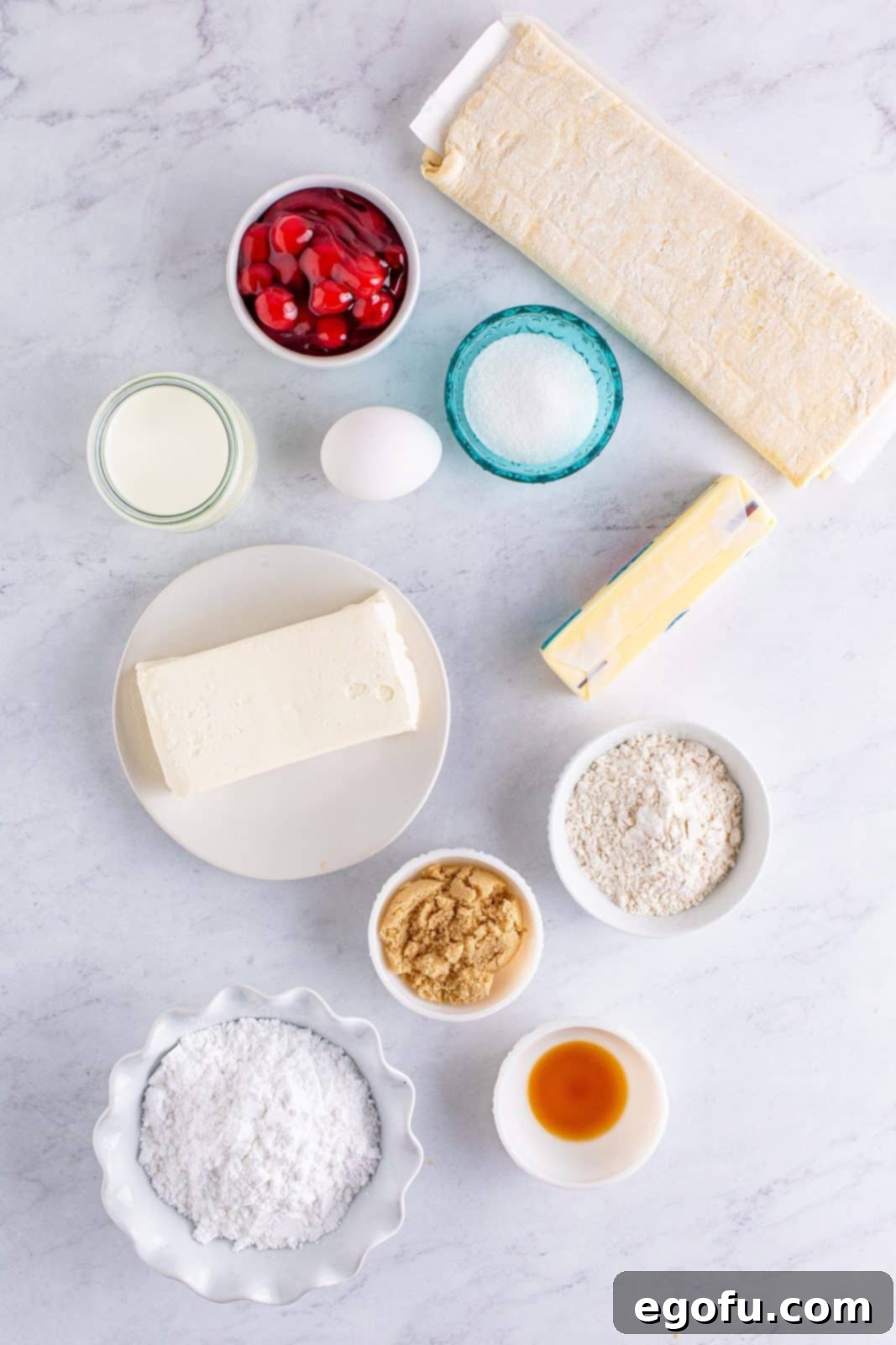 Buttery Cherry Crumble Danishes 4 Ingredients needed: cream cheese, granulated sugar, vanilla extract, light brown sugar, unsalted butter, all-purpose flour, puff pastry, cherry pie filling, egg, water, powdered sugar and whole milk.