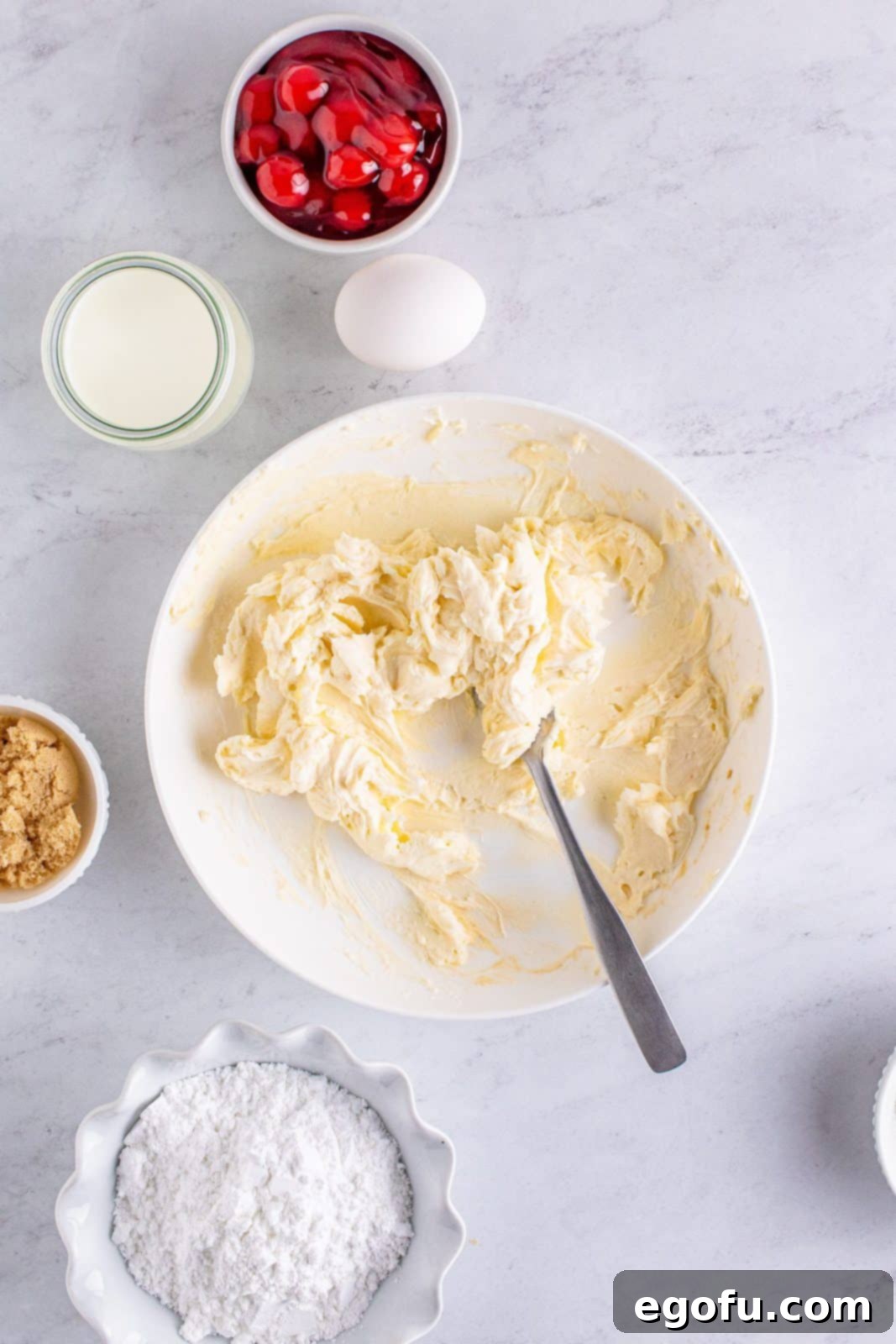 Buttery Cherry Crumble Danishes 5 Cream cheese mixture mixed together in bowl.