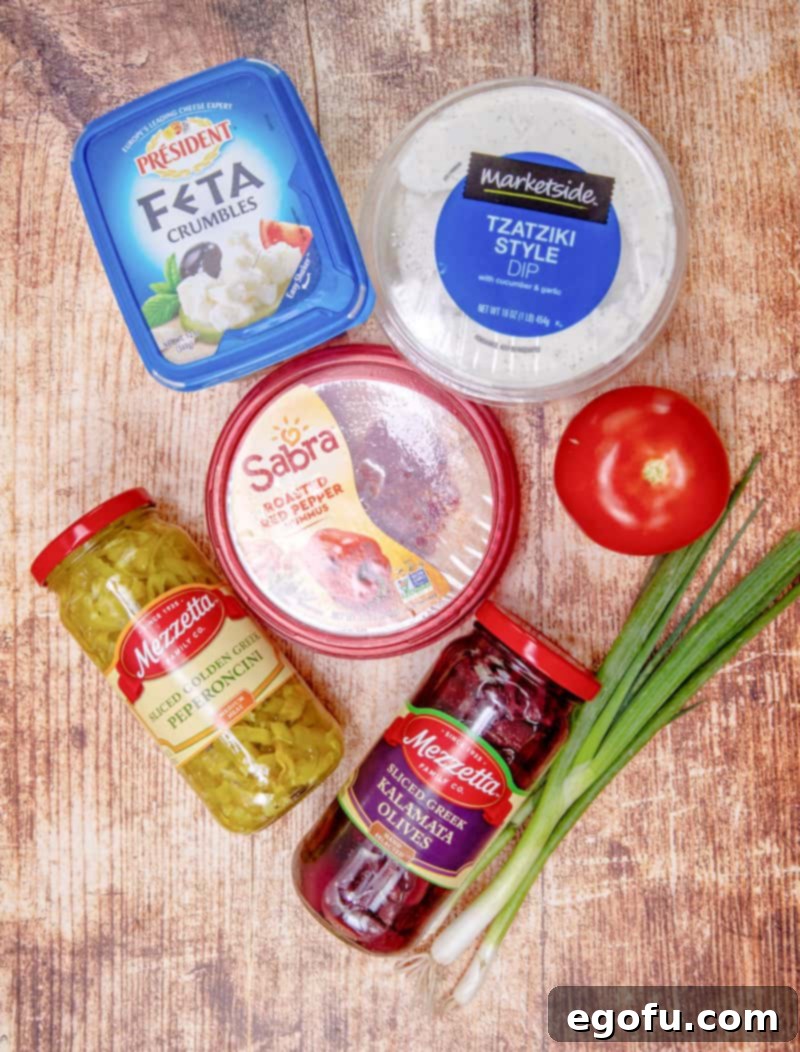 red pepper hummus, Feta cheese, tzatziki dip, peperoncini peppers, kalamata olives, tomato and green onions.