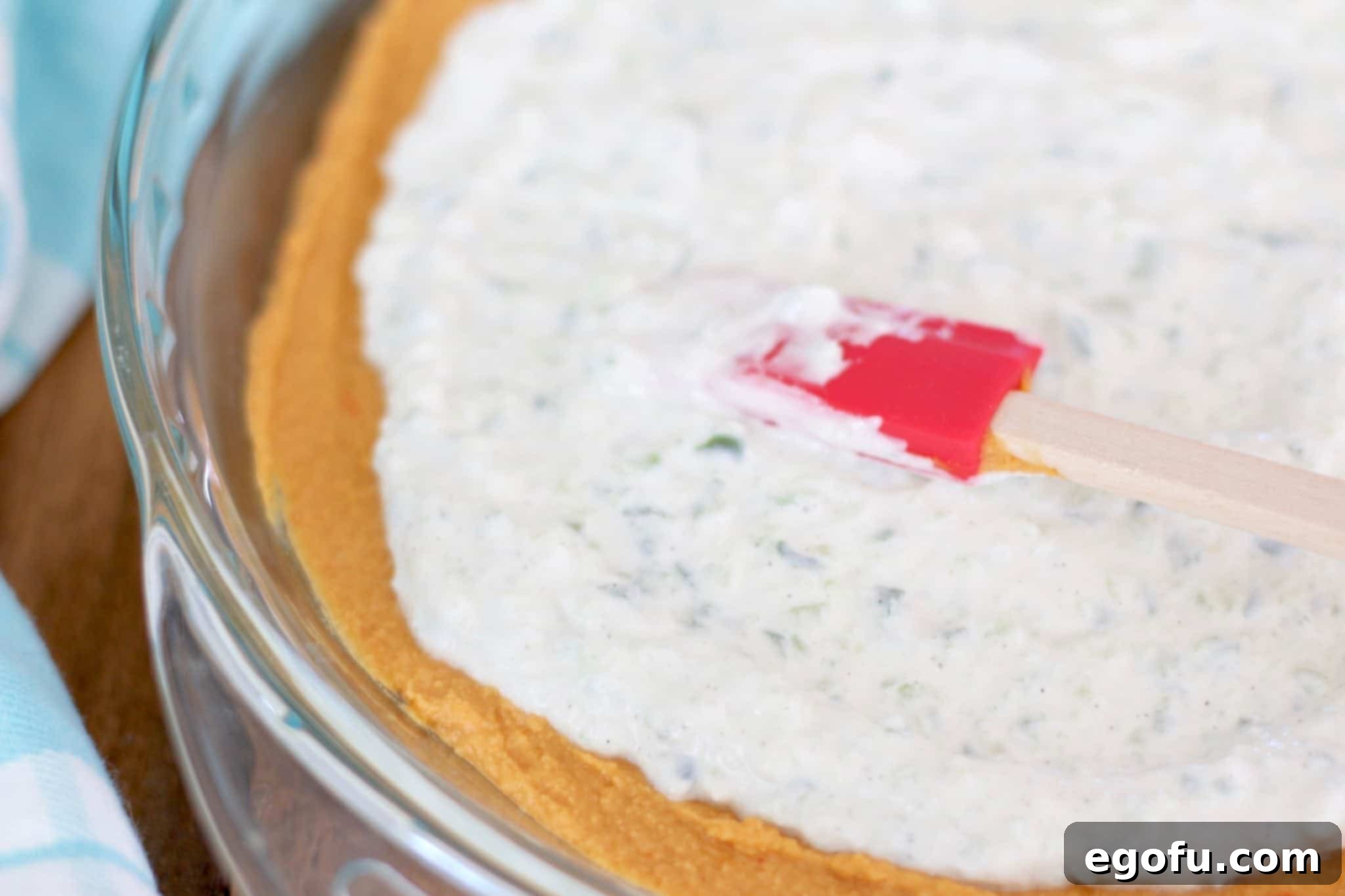 tzaziki dip spread on top of roasted red pepper hummus layer.