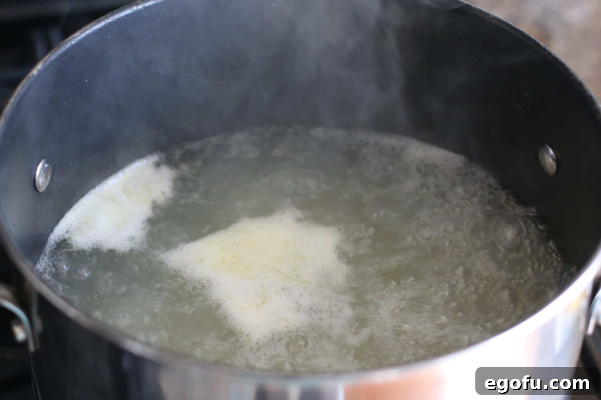 Homestyle Pimiento Macaroni Salad 5 boiling macaroni noodles in a large pot.