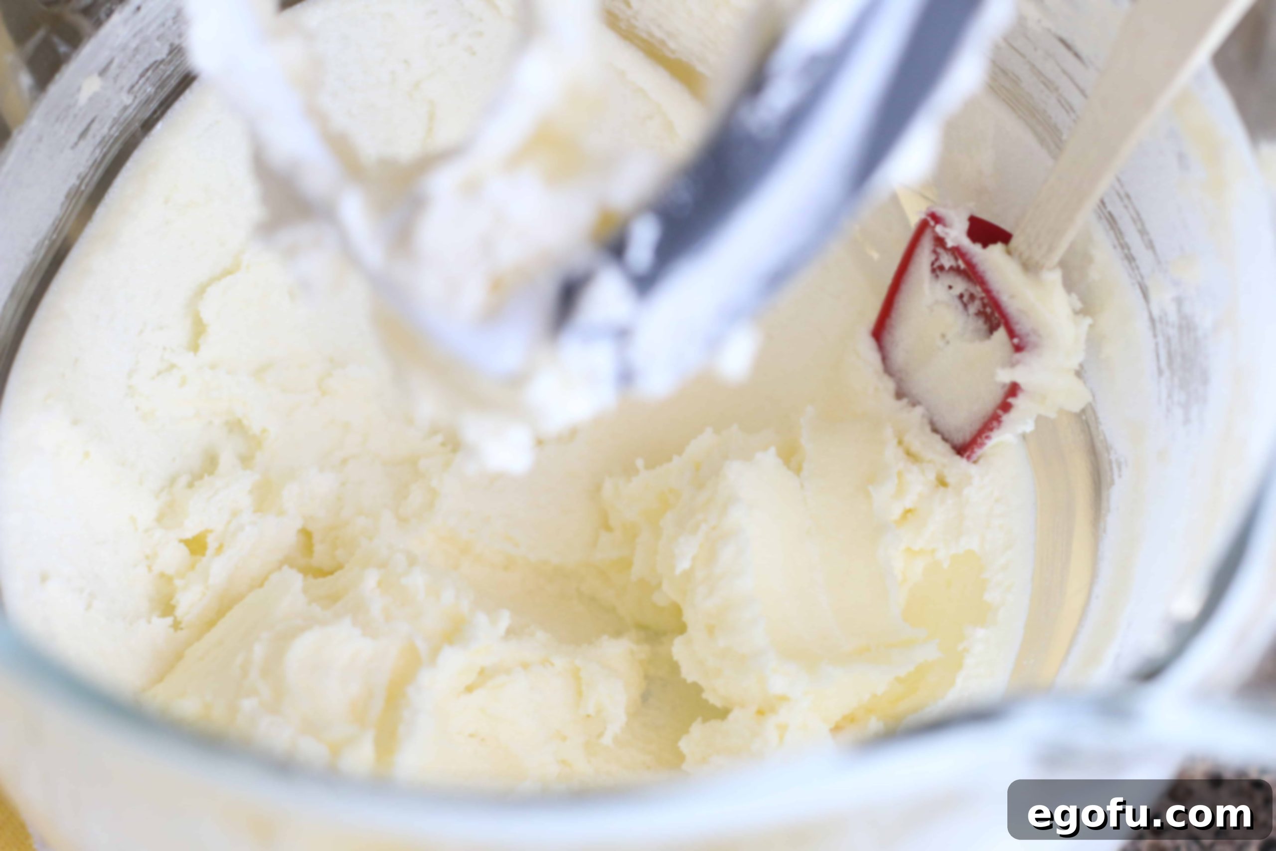 Heirloom Southern Pecan Pound Cake 8 Softened butter and granulated sugar being creamed together in the bowl of an electric stand mixer, forming a light and fluffy mixture.