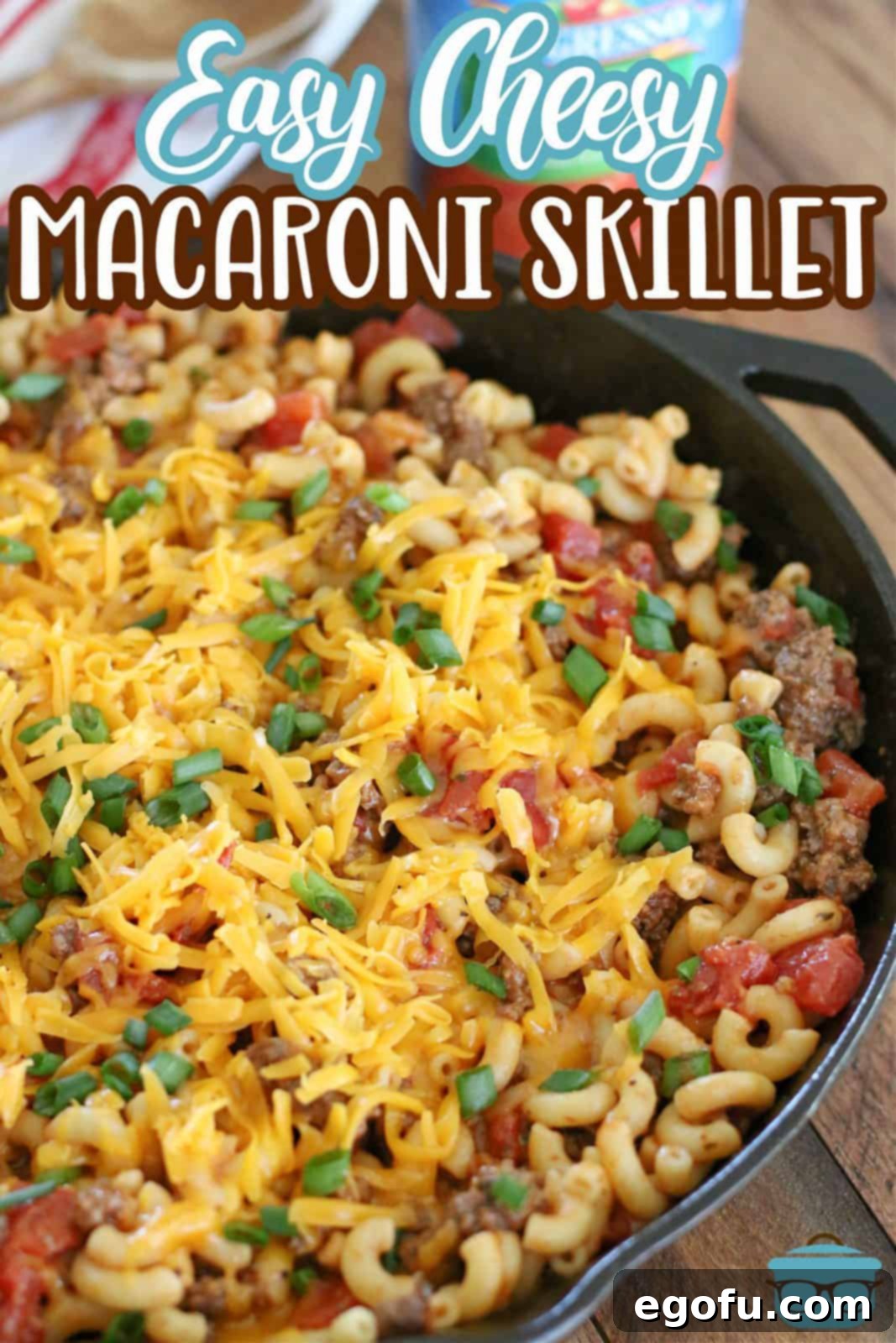 A fully cooked Easy Cheesy Tomato Macaroni Skillet meal, fresh from The Country Cook recipe, served in a cast iron skillet with melted cheese on top, ready to eat.