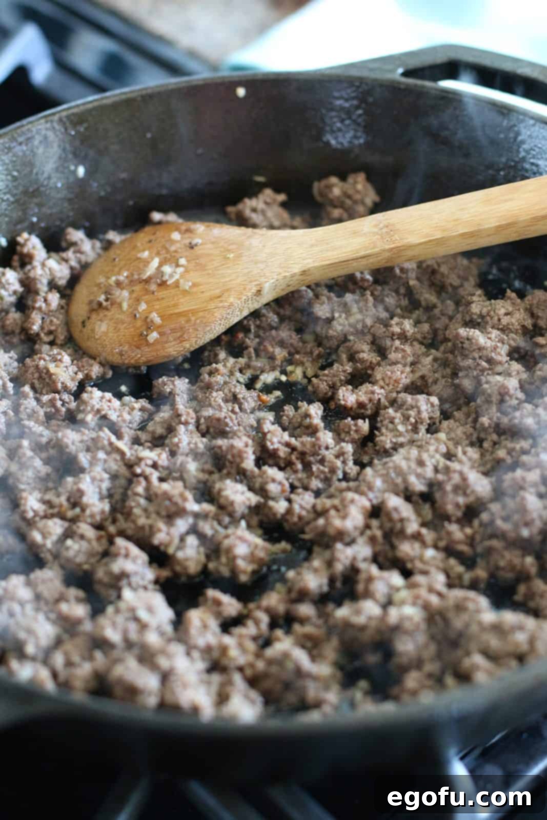 Perfectly cooked and crumbled lean ground beef resting in a skillet, with no excess fat to drain, ready for the next ingredients.