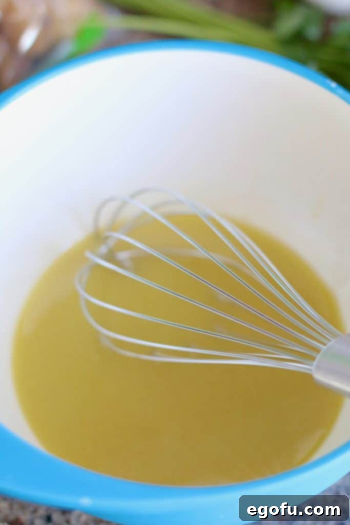 Emulsified mixture of vinegar and mustard, forming the creamy base of the vinaigrette.