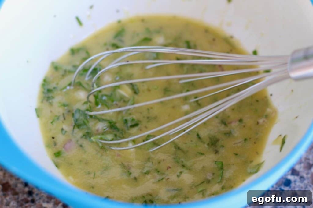 The finished fresh herb vinaigrette, fully combined and ready to dress the potatoes.