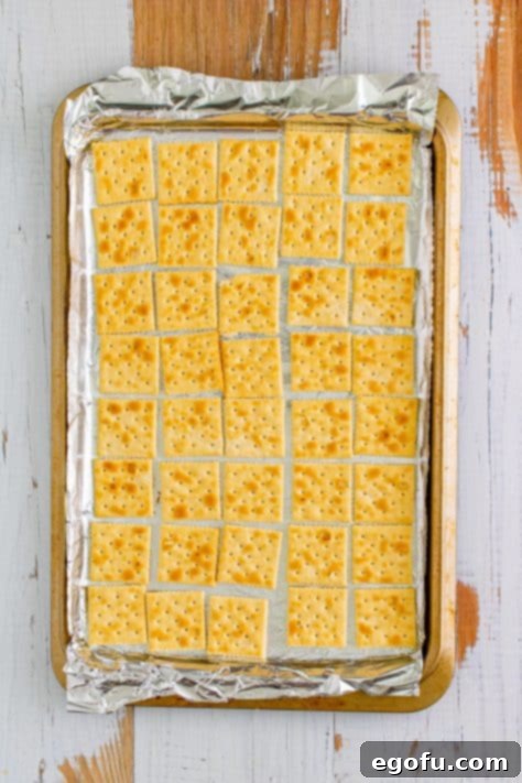 Christmas Caramel Cracker Crunch 11 crackers lined up on baking sheet.