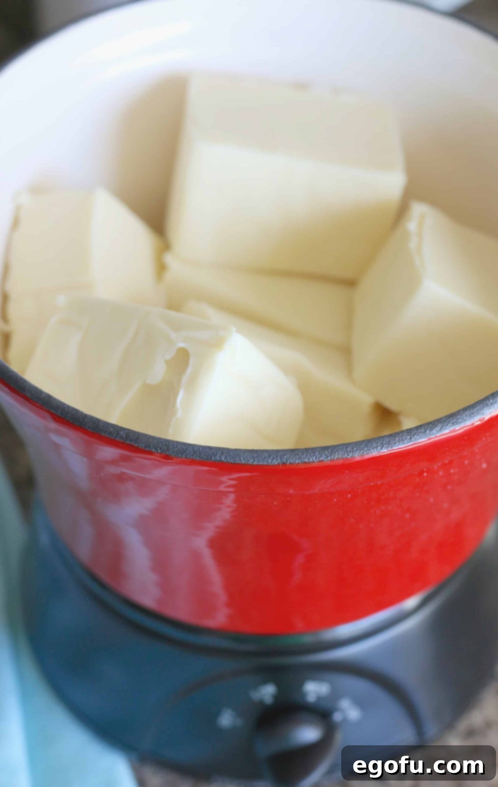 cubed queso blanco Veleta cheese in mini slow cooker.