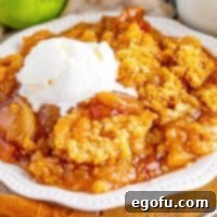 Crock Pot Apple Dump Cake shown on a white plate.