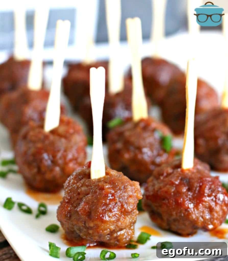 Homemade Appetizer Party Meatballs on a white platter sprinkled with sliced green onion