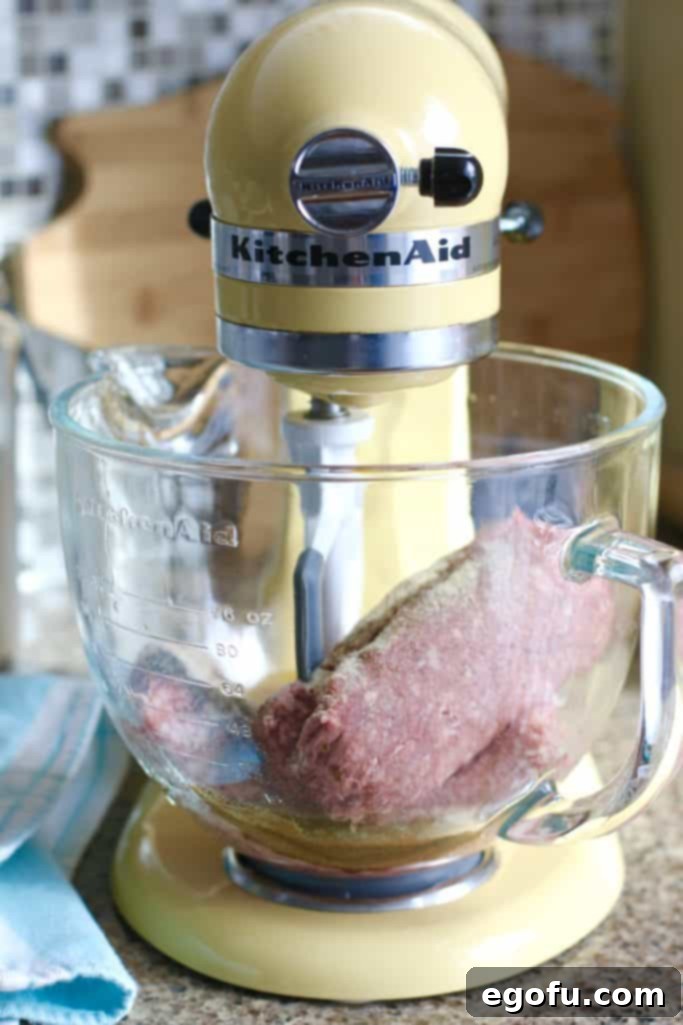 meatball ingredients added into the bowl of a electric stand mixer