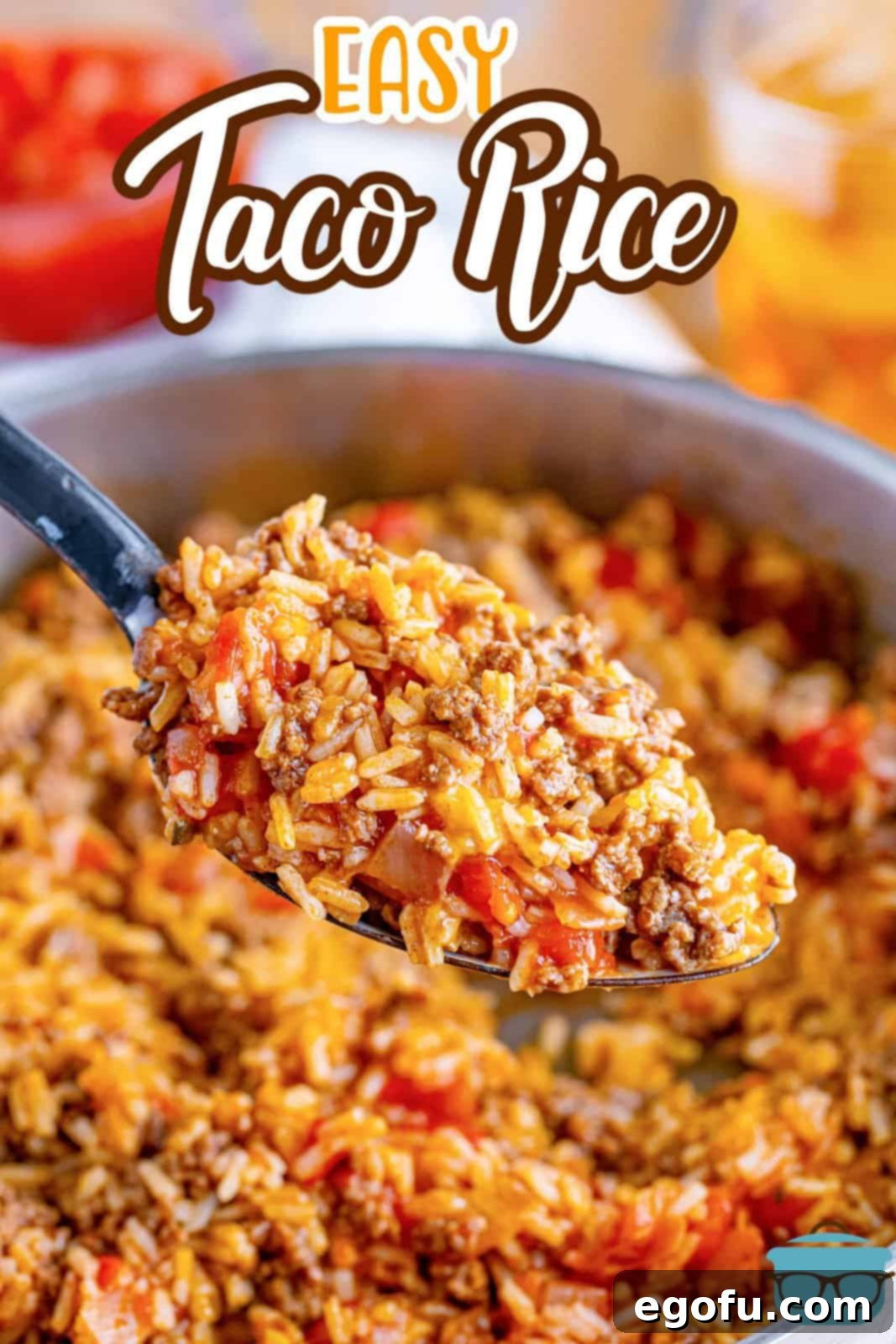 Okinawan Taco Rice 4 a large spoon scooping up a serving of Taco Rice over a skillet.