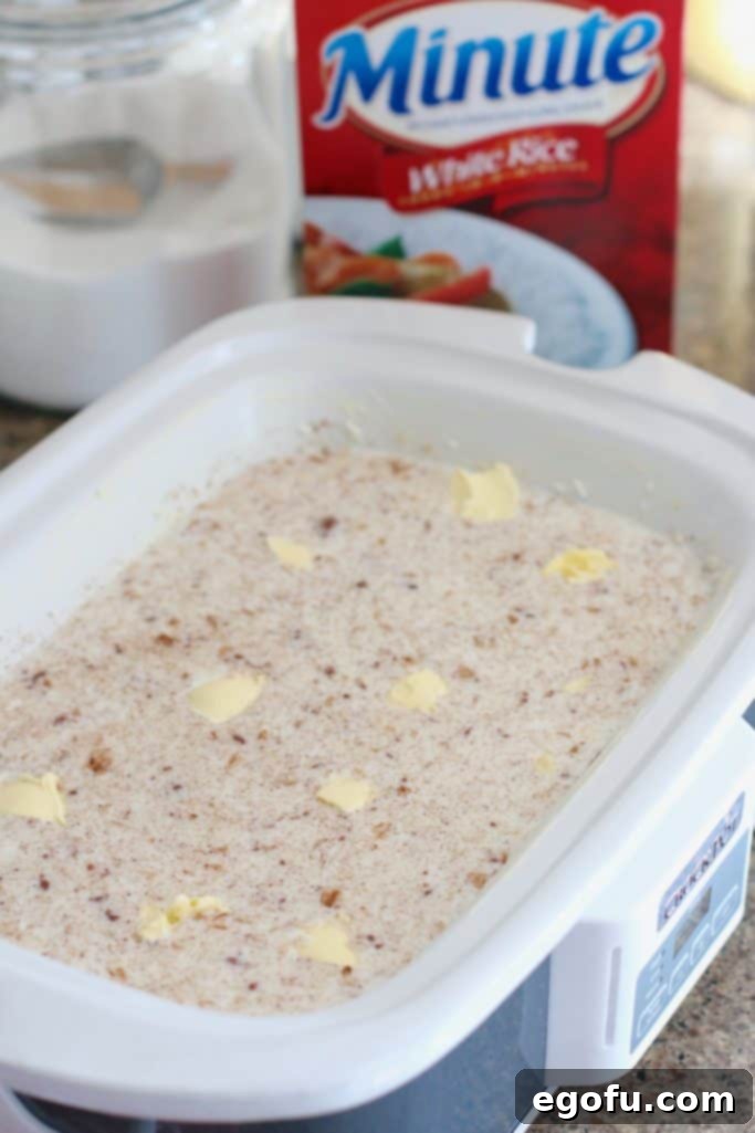 Creamy Crock Pot Rice Pudding 7 pats of butter added to rice pudding mixture in slow cooker.