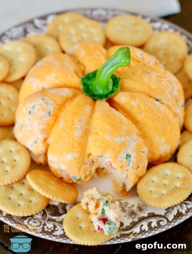 The Great Pumpkin Cheese Ball 17 Vegetable, ranch dressing cheeseball spread on Ritz butter cracker.