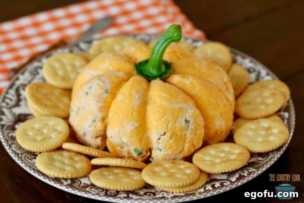 The Great Pumpkin Cheese Ball 18 Easy Pumpkin Shaped Cheeseball on a serving plate.