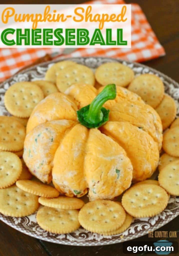 The Great Pumpkin Cheese Ball 4 Pumpkin-Shaped Cheeseball recipe from The Country Cook. Cheeseball shown on a brown and white plate with Ritz crackers surrounding the cheeseball.