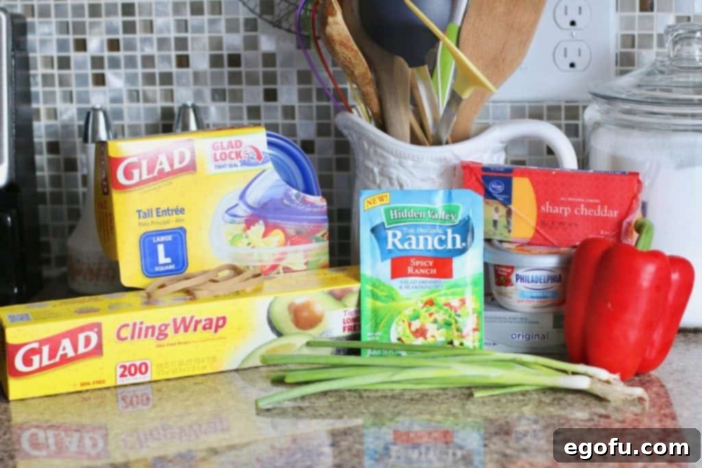 The Great Pumpkin Cheese Ball 5 Hidden Valley Ranch dip dressing mix, shredded cheddar cheese, vegetable cream cheese, green onions, green and red pepper, cream cheese.
