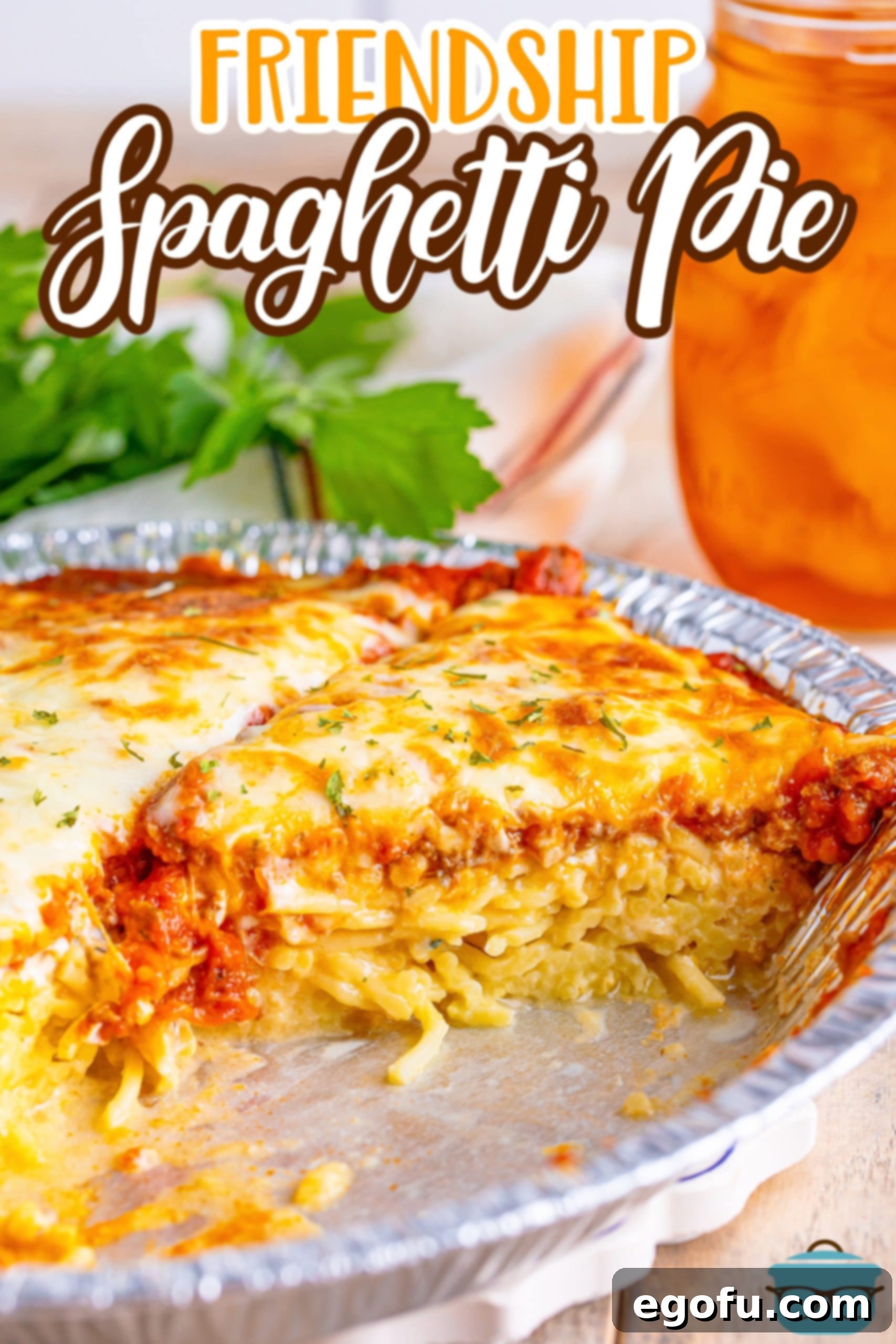 A pie plate of Spaghetti Pie with a piece missing.