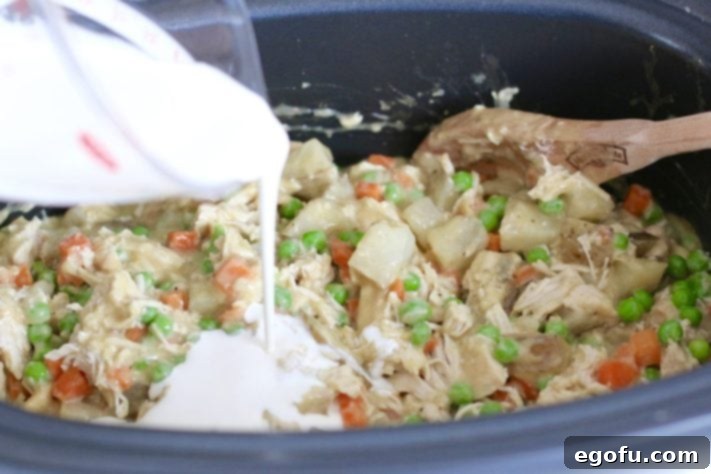 pouring heavy cream into slow cooker.