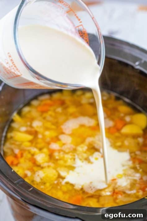 Heavy cream being poured in a Crock Pot.