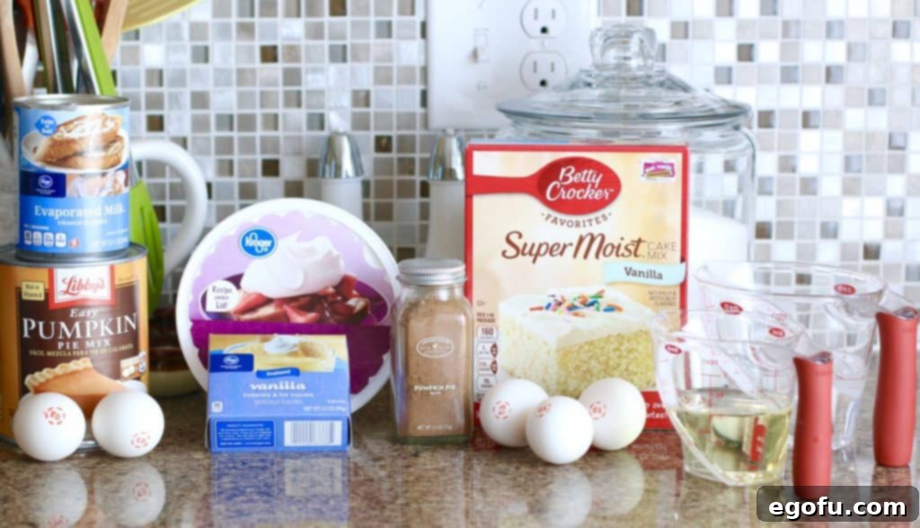 Harvest Moon Pumpkin Dream 4 A flat lay photograph displaying all the ingredients needed for the Magic Pumpkin Layer Cake: vanilla cake mix, pumpkin pie mix, evaporated milk, eggs, instant vanilla pudding, pumpkin pie spice, cold milk, and a tub of whipped topping.