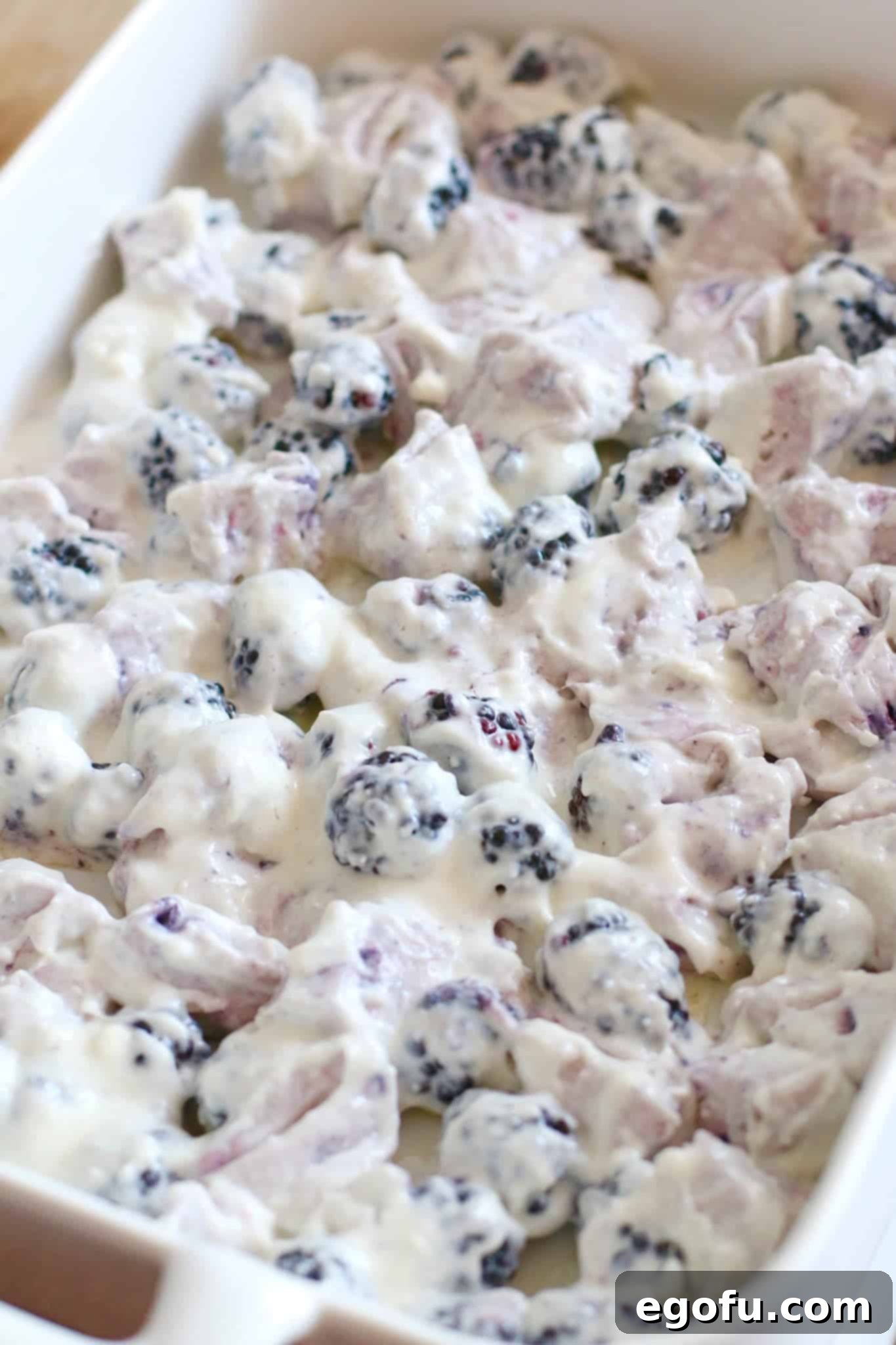 Blackberry Burst Bake 11 The blueberry biscuit, cream cheese, powdered sugar, and blackberry mixture spread evenly into a 13x9 baking dish.