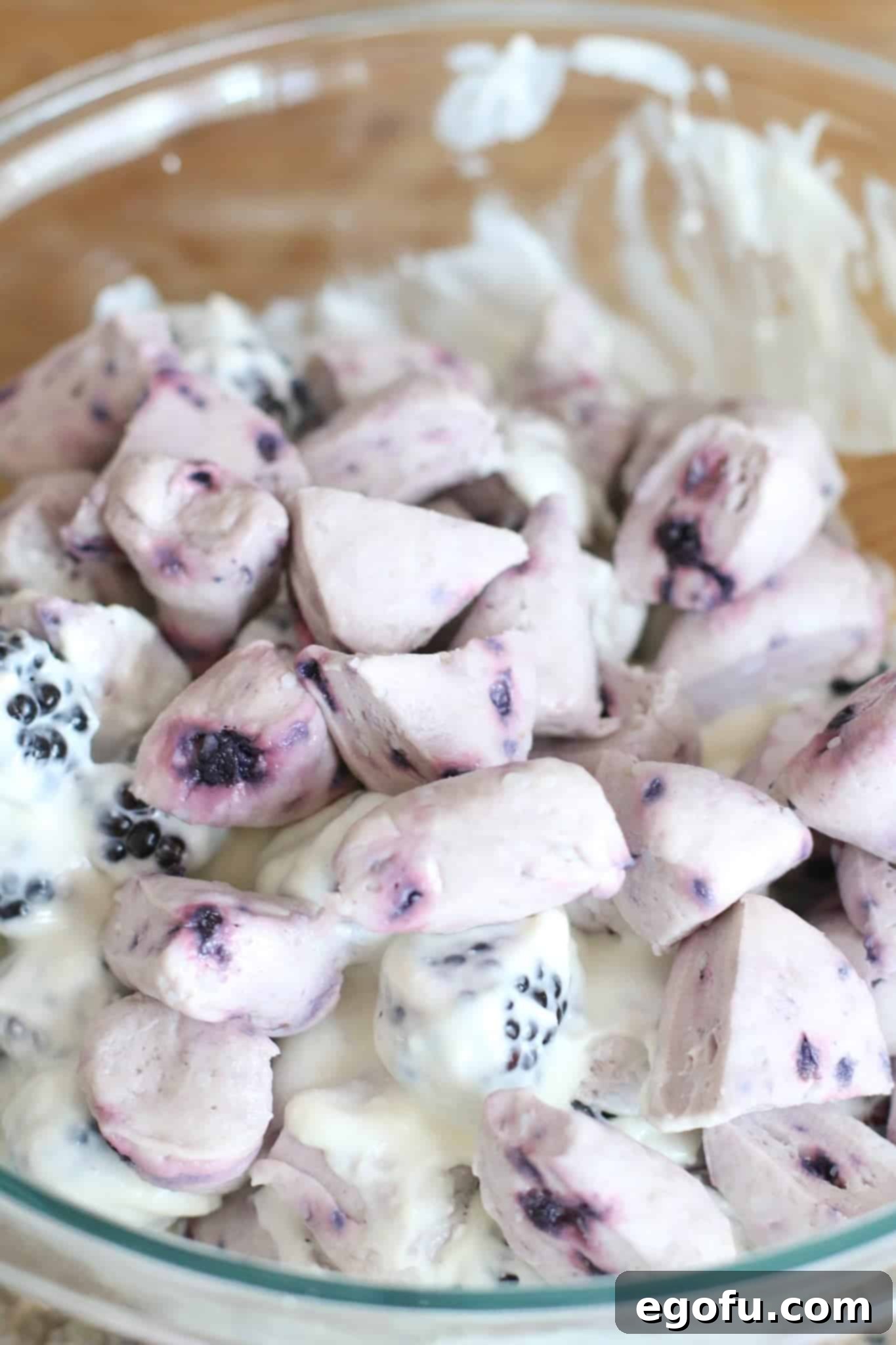 Blackberry Burst Bake 10 Blueberry biscuits added to the cream cheese mixture with blackberries, ready to be combined.